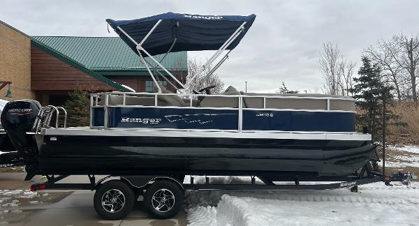 Ranger Reata 200C 2024 Ranger Reata 200C pontoon boat with canopy on trailer, winter setting.