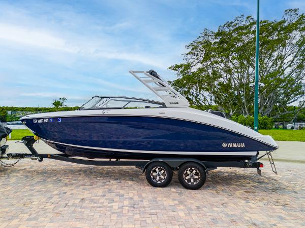 Yamaha Boats 252S 2021 Yamaha Boats 252S on trailer, sleek design, blue hull, parked outdoors.