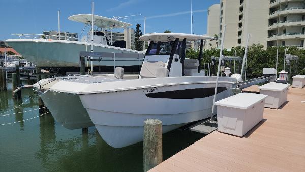 Aquila 28 Molokai 2022 Aquila 28 Molokai boat docked at marina, clear sky, modern design.