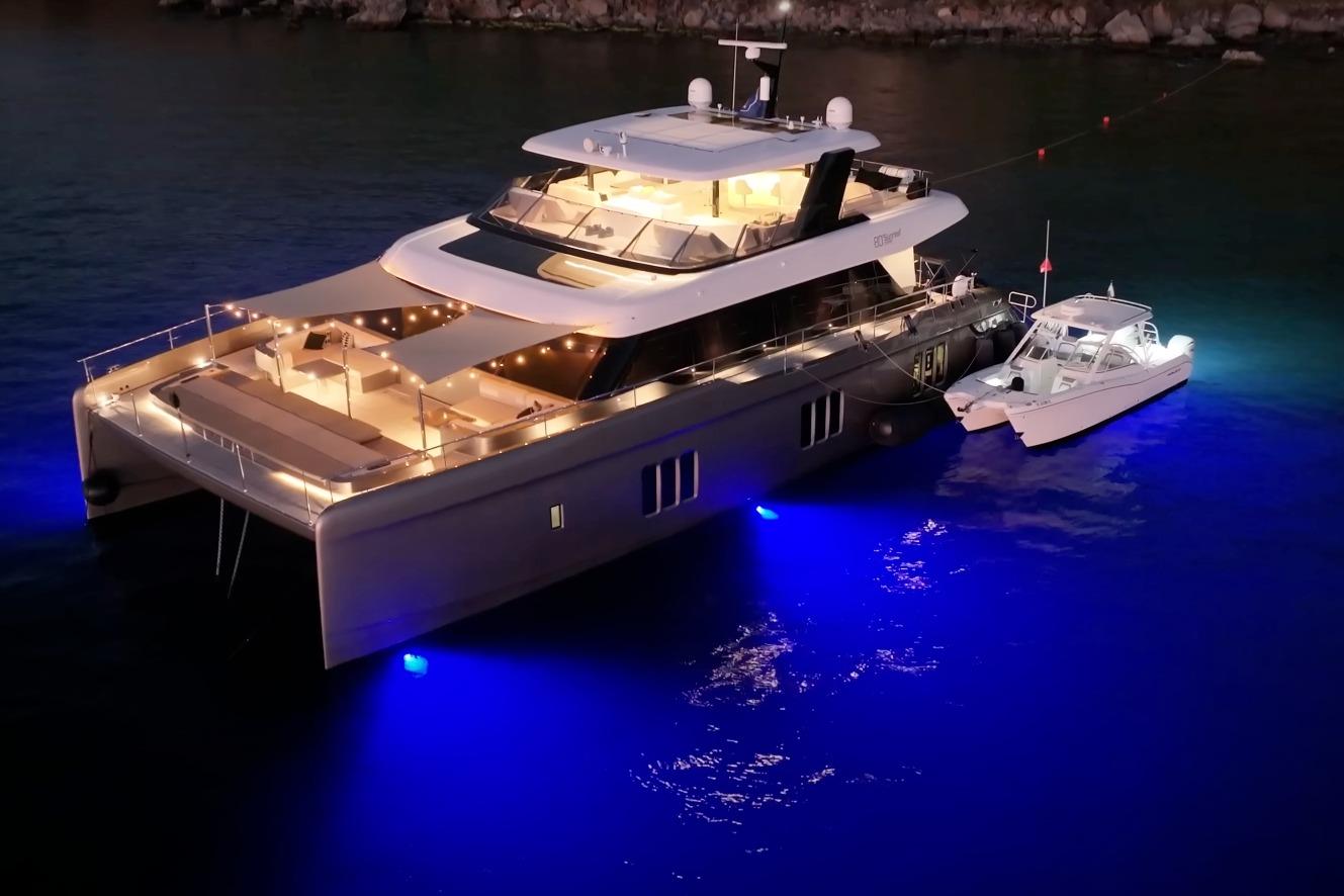 Sunreef 80 Power | Fractional Ownership (1/6th) Luxurious 2020 Sunreef 80 Power yacht with ambient lighting, docked at night.