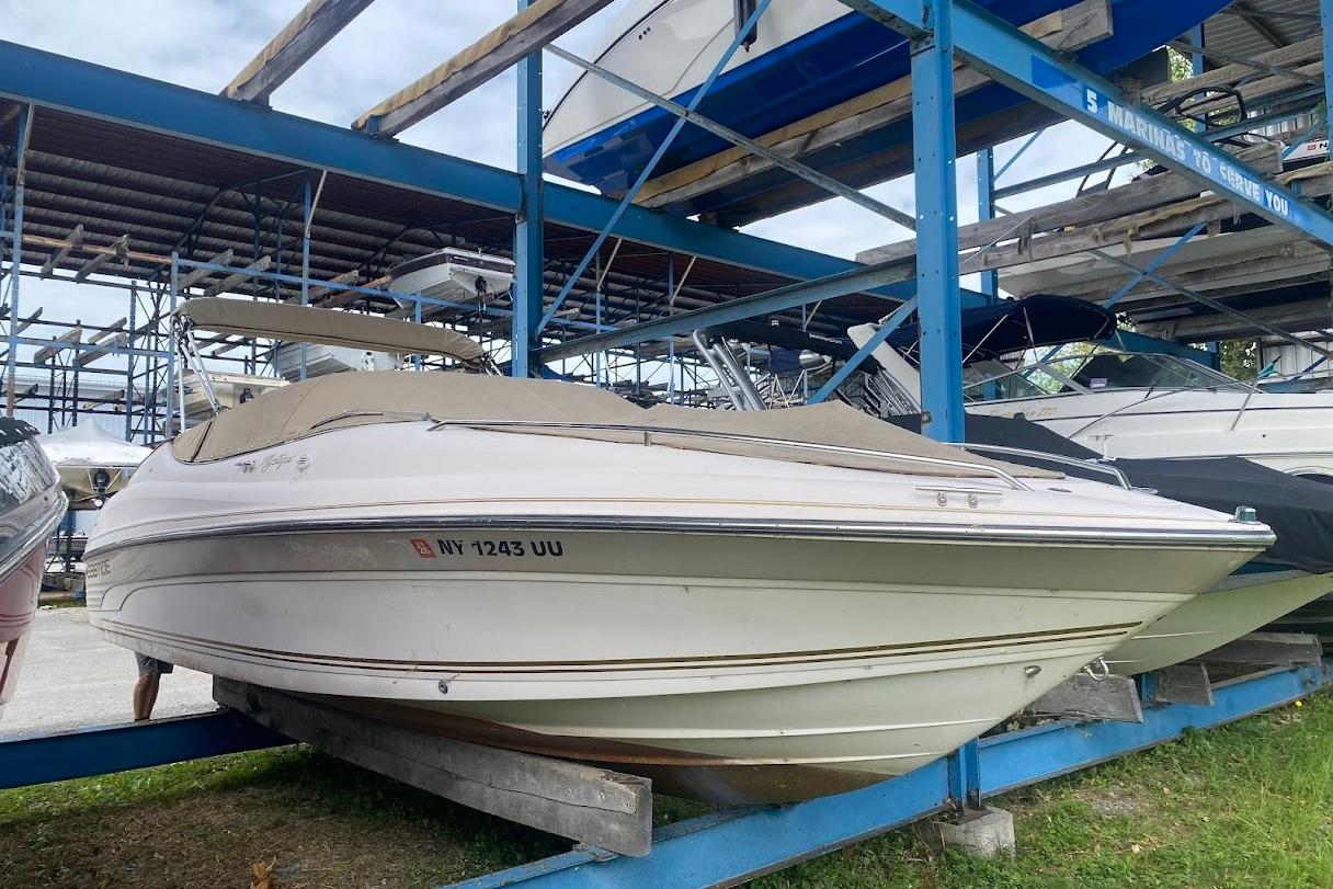 Ebbtide 2300 1999 Ebbtide 2300 boat stored on a rack, covered and secured.