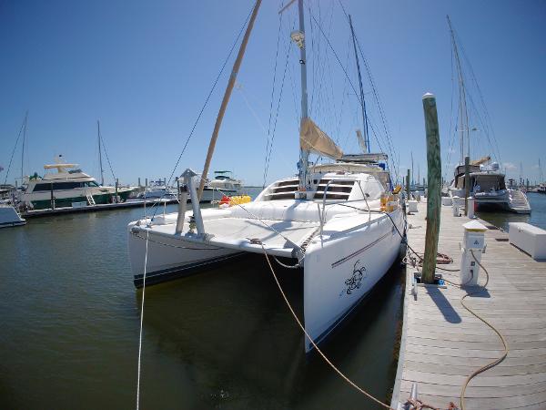 Leopard 40 2005 Leopard 40 catamaran docked at marina under clear blue sky.