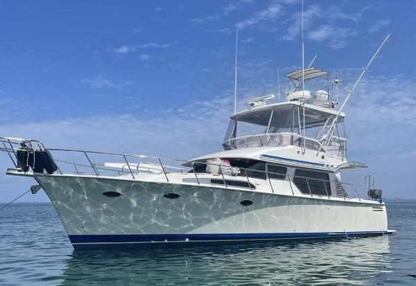 Mikelson 43 Sportfisher 2004 Mikelson 43 Sportfisher yacht on calm water under a clear blue sky.