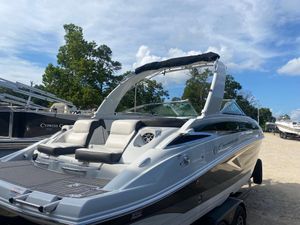 Crownline 265 SS 2022 Crownline 265 SS boat with sleek design, parked outdoors under a clear sky.