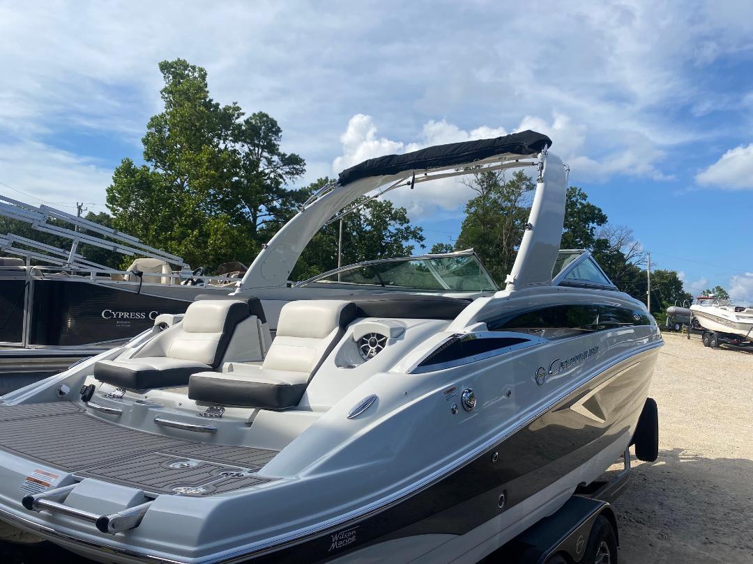 Crownline 265 SS 2022 Crownline 265 SS boat with sleek design, parked outdoors under a clear sky.