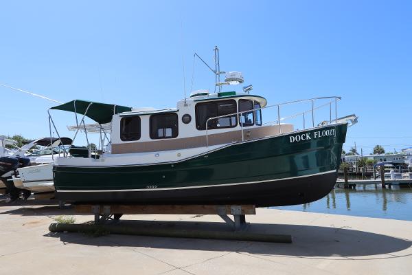 Ranger Tugs R-25 2008 Ranger Tugs R-25 boat on dry dock, green hull, sunny day.