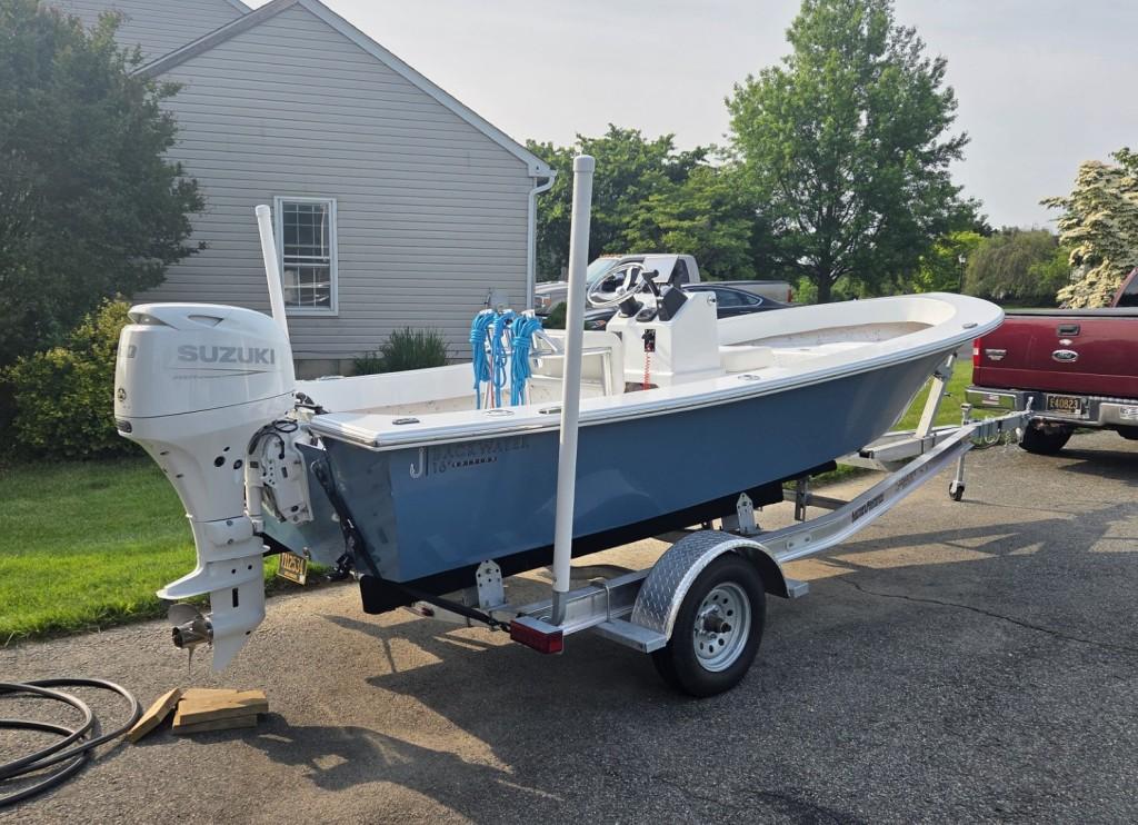 Layton Bay Backwater 16 2022 Layton Bay Backwater 16 boat on trailer with Suzuki outboard motor.