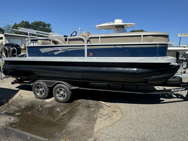 Ranger R 200C 2023 Ranger R 200C pontoon boat on trailer, parked outdoors.