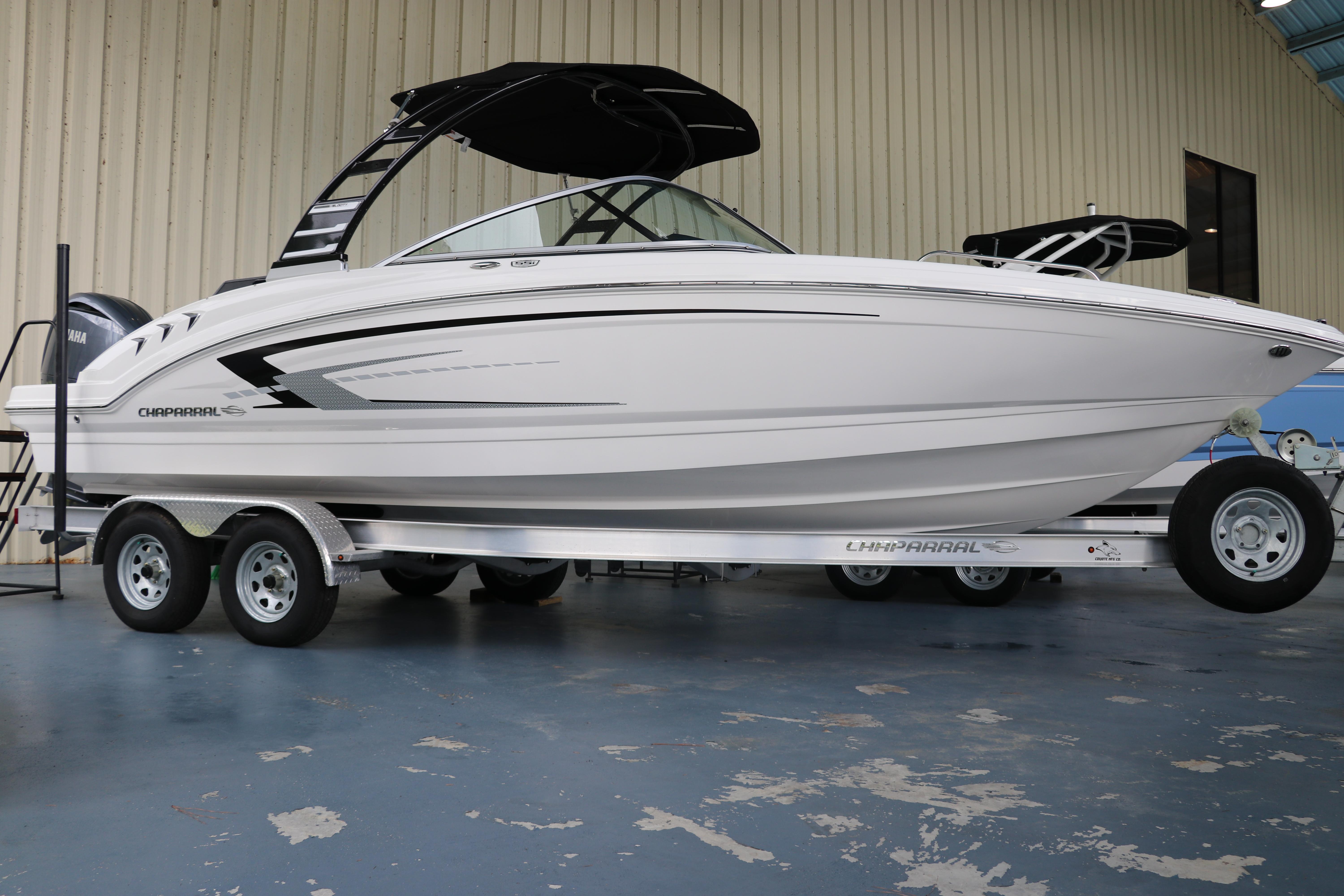 Chaparral 23 SSi OB 2024 Chaparral 23 SSi OB boat on trailer in indoor showroom.