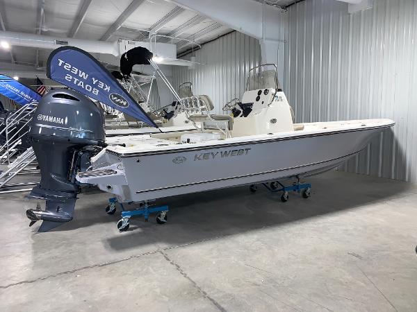 Key West 210 Bay Reef 2024 Key West 210 Bay Reef boat in showroom with Yamaha outboard motor.