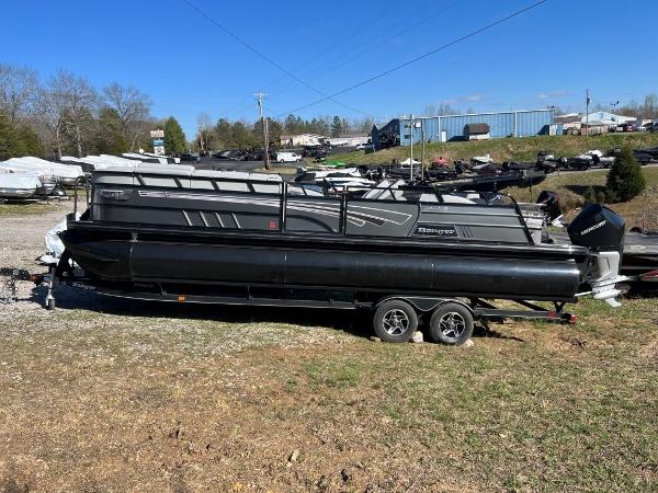 Ranger 2500LS 2023 Ranger 2500LS pontoon boat on a trailer in a boatyard.