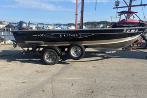 Lund 1600 Fury Tiller 2013 Lund 1600 Fury Tiller boat on trailer at marina, sunny day.