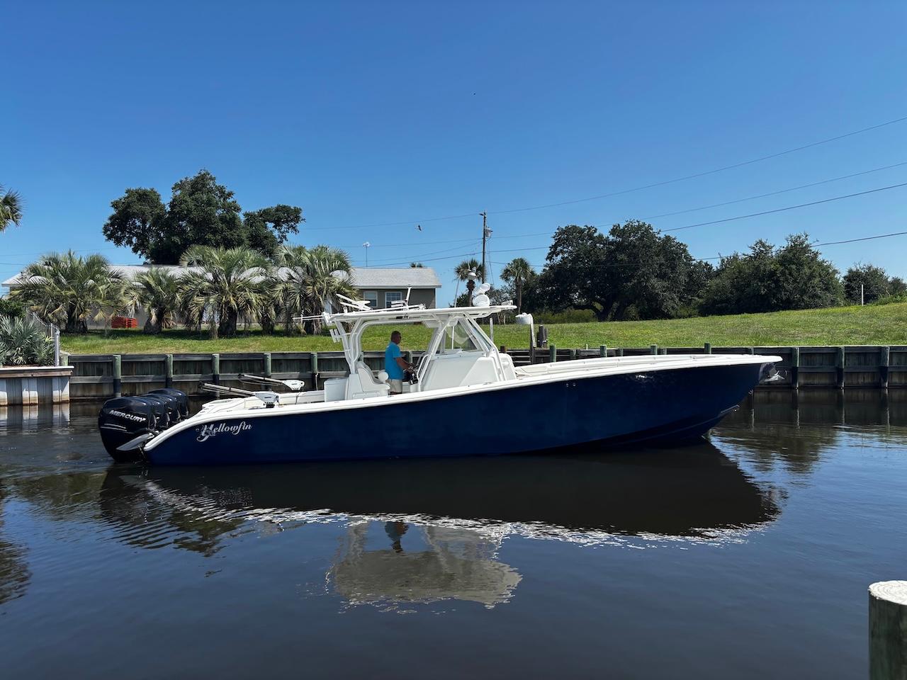 Yellowfin 39 2015 Yellowfin 39 boat on calm water, clear sky, and lush greenery in the background.