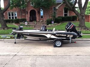 Nitro Z-6 2012 Nitro Z-6 boat on trailer, parked in front of a brick house.