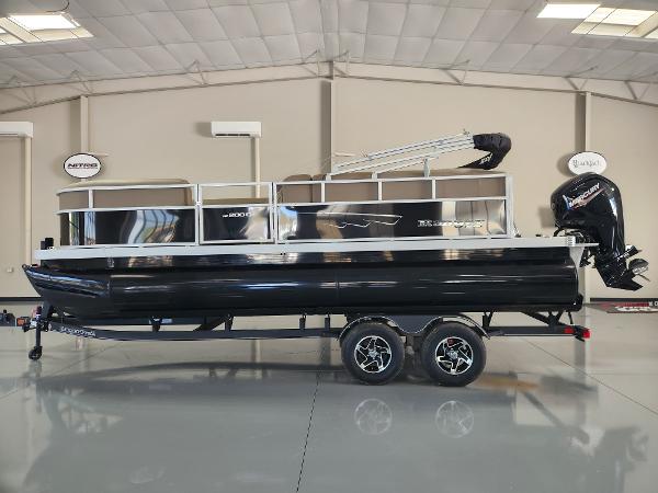 Ranger 200C 2025 Ranger 200C pontoon boat in showroom, black exterior, dual-axle trailer, outboard motor.