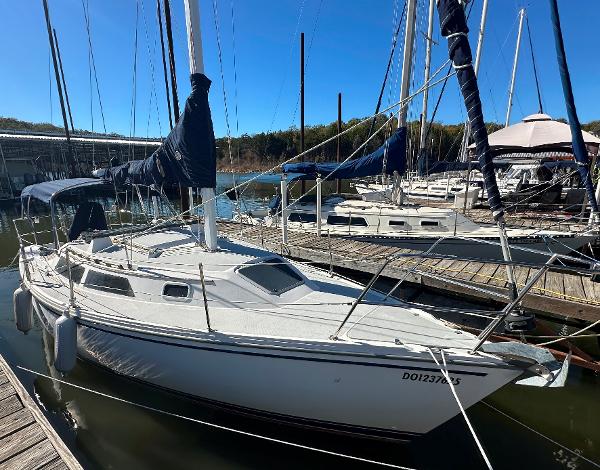 Catalina 28 1991 Catalina 28 sailboat docked at marina under clear blue sky.