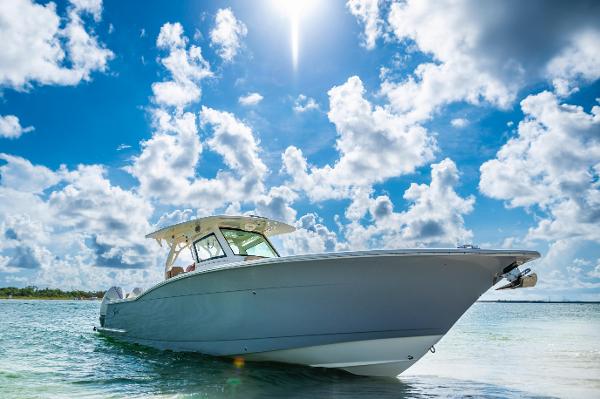 Scout 355 LXF 2019 Scout 355 LXF boat on clear water under a bright, sunny sky.