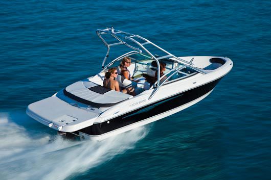 Four Winns H180 Manufacturer Provided Image: 2011 Four Winns H180 boat cruising on blue water.