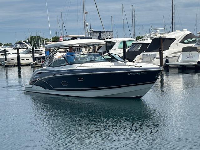 Formula 350 CBR 2017 Formula 350 CBR boat cruising in a marina with other yachts docked nearby.
