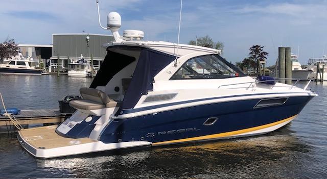 Regal 35 Sport Coupe 2014 Regal 35 Sport Coupe boat docked at marina, featuring sleek design and modern amenities.