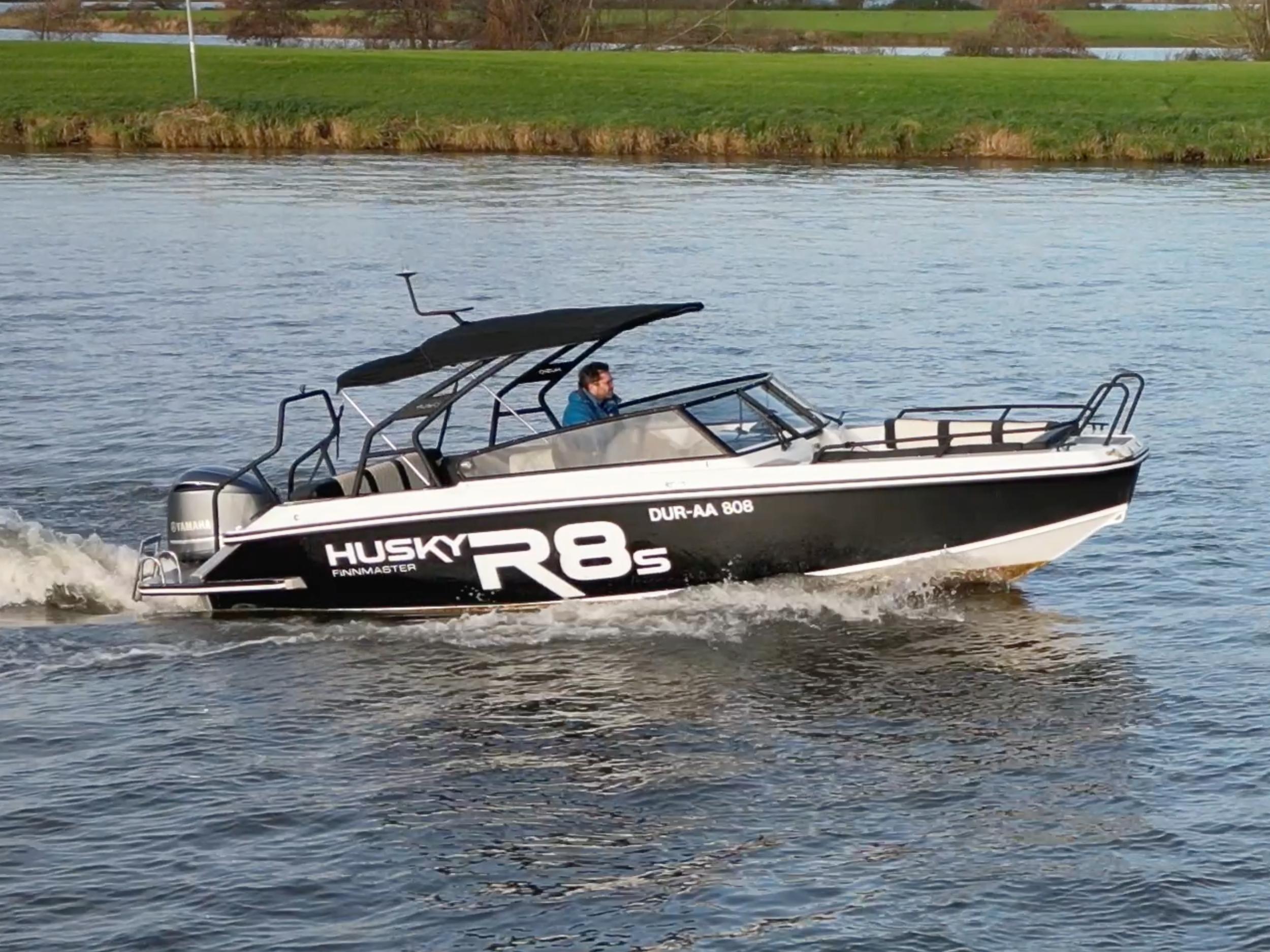 Finnmaster R8S Finnmaster 2018 Finnmaster R8S boat cruising on a river with green banks.