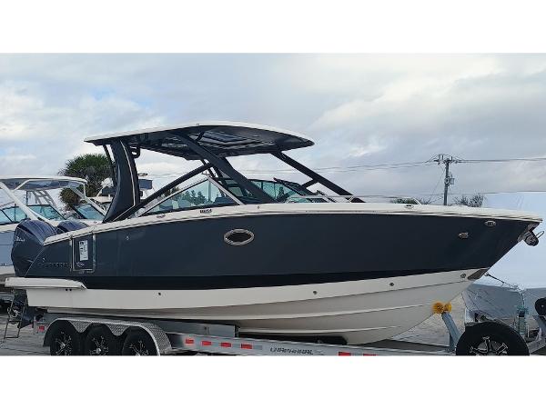 Chaparral 280 OSX 2024 Chaparral 280 OSX boat on trailer, sleek design, overcast sky background.