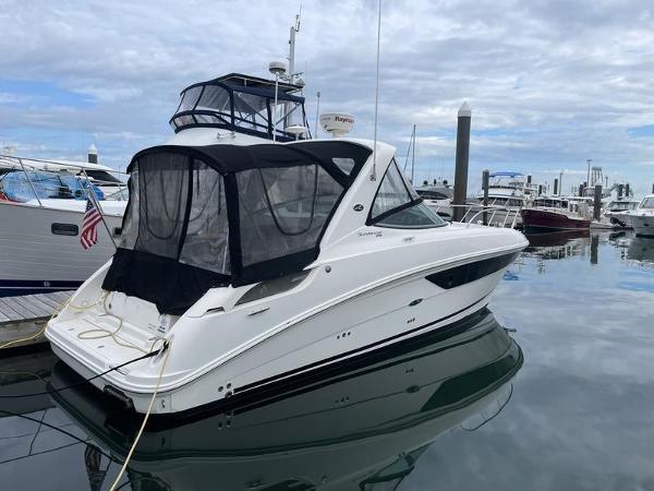 Sea Ray 310 Sundancer 2014 Sea Ray 310 Sundancer docked at a marina with other boats.