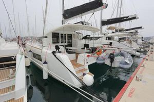 Lagoon 40 2018 Lagoon 40 catamaran docked at marina, featuring modern design and spacious deck.
