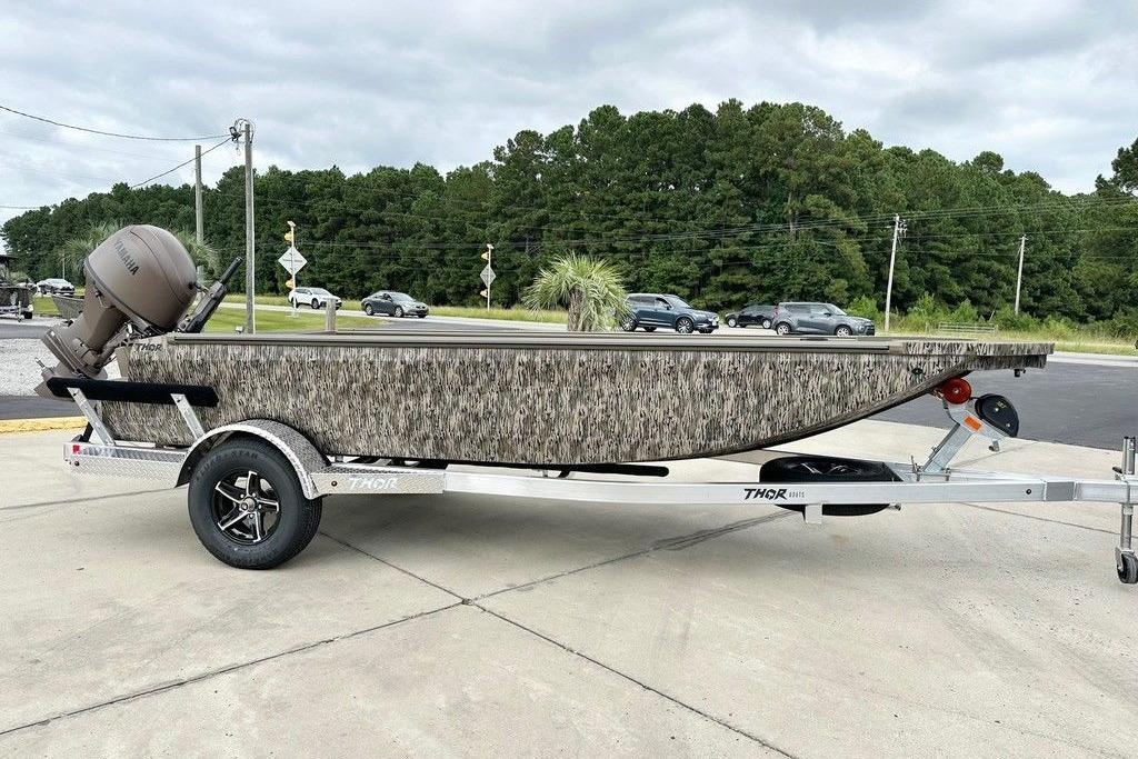 Thor 1754 Timber Hammer 2026 Thor 1754 Timber Hammer boat on trailer, camo design, parked outdoors.