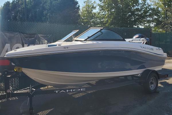 Tahoe 185 S 2024 Tahoe 185 S boat on trailer, parked outdoors.