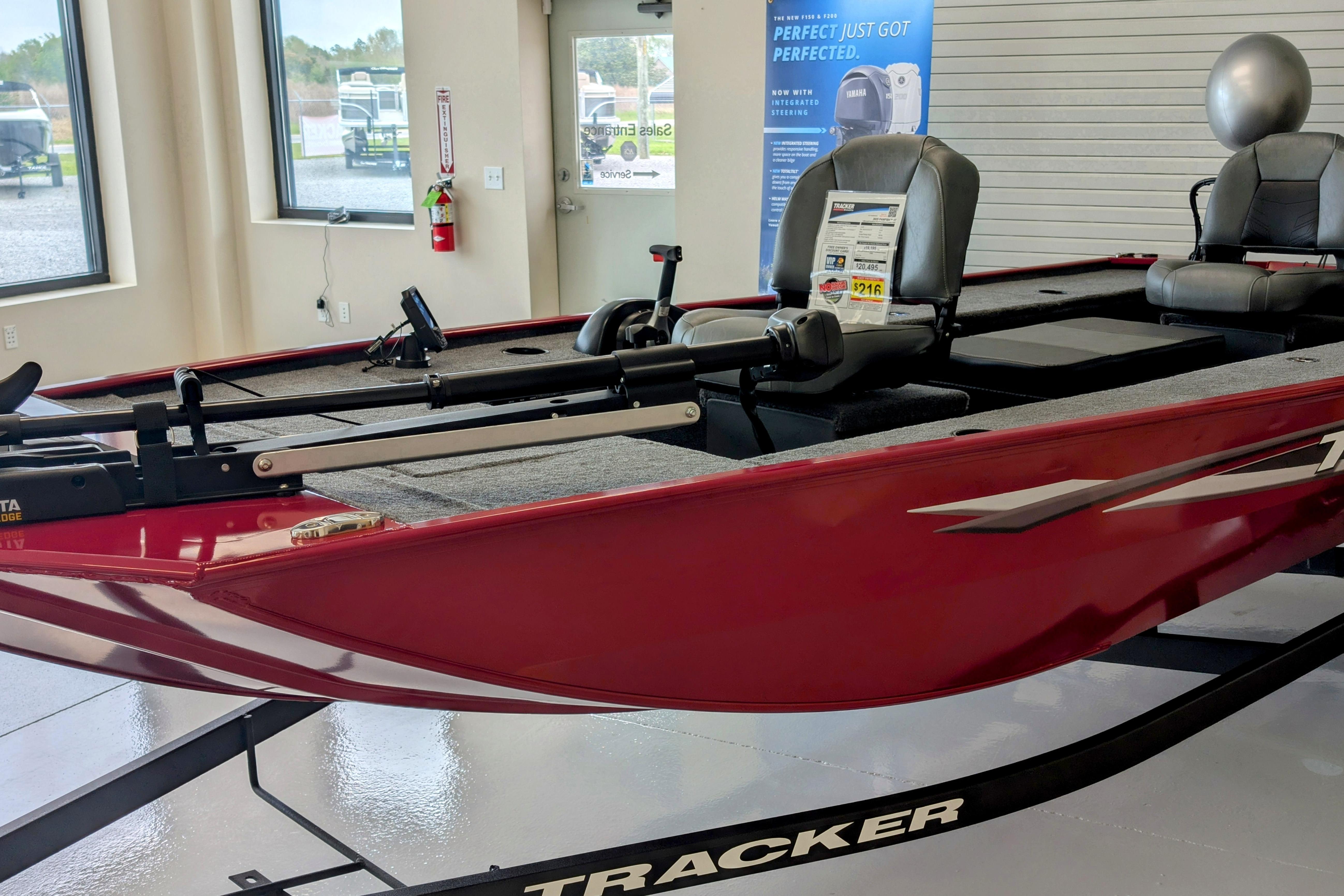 Tracker Panfish 17 2025 Tracker Panfish 17 boat in showroom, red exterior, modern design.