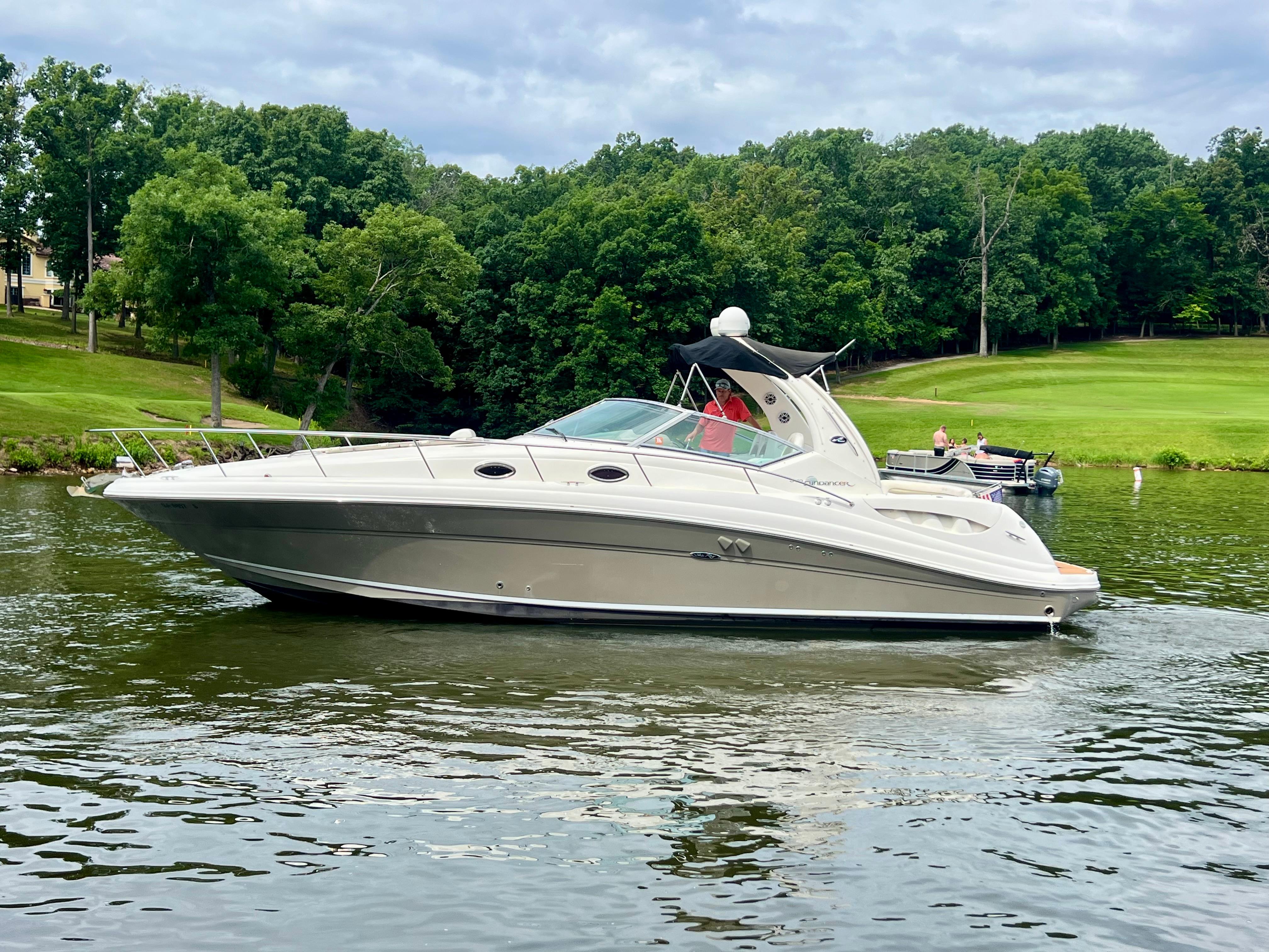 Sea Ray 340 Sundancer 2006 Sea Ray 340 Sundancer cruising on a scenic lake with lush green trees.