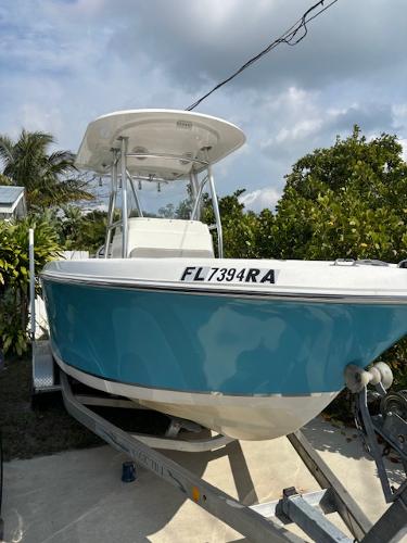 Release 208 RX 2016 Release 208 RX boat on trailer, blue hull, parked outdoors.