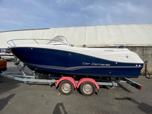 Jeanneau CAP CAMARAT 6.5 WA-3 2018 Jeanneau CAP CAMARAT 6.5 WA-3 boat on trailer, blue and white design.