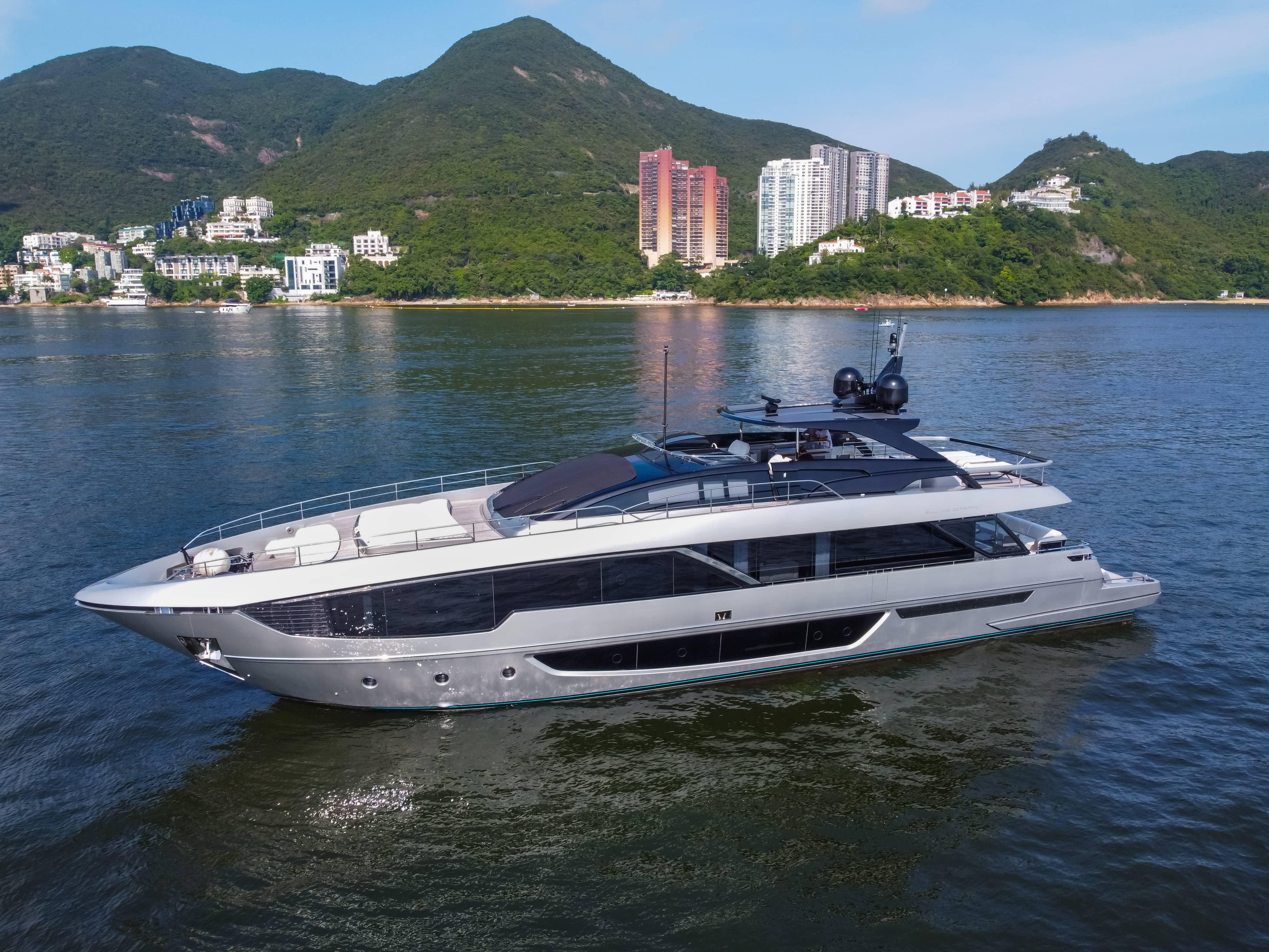 Riva 102' Corsaro Luxurious 2024 Riva 102' Corsaro yacht cruising near scenic coastal landscape.
