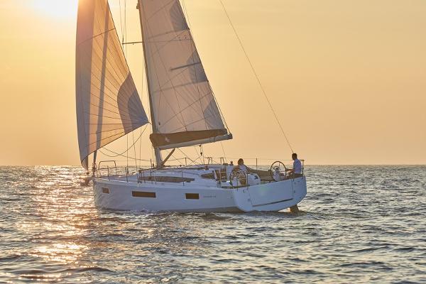 Jeanneau Sun Odyssey 410 2026 Jeanneau Sun Odyssey 410 sailing at sunset on open water.