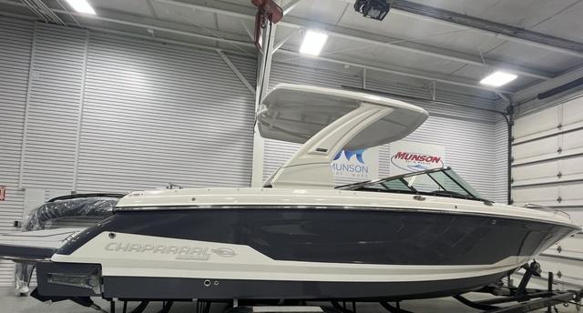 Chaparral 30 Surf 2025 Chaparral 30 Surf boat in showroom, side view, sleek design.