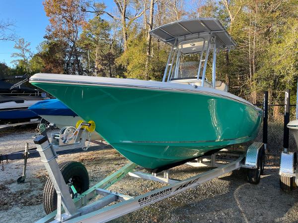 Key West 203 FS 2024 Key West 203 FS boat on trailer, teal hull, parked outdoors.
