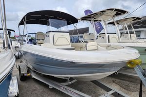 Stingray 206cc 2023 Stingray 206cc boat with canopy on trailer, displayed at a dealership.