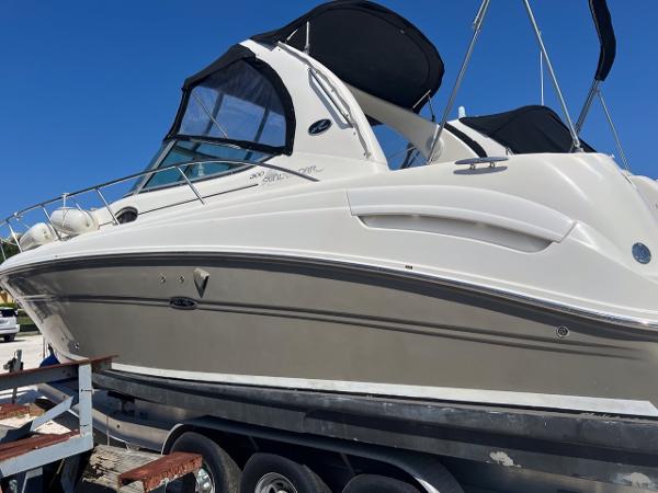 Sea Ray 300 Sundancer 2006 Sea Ray 300 Sundancer boat on trailer, featuring sleek design and black canopy.