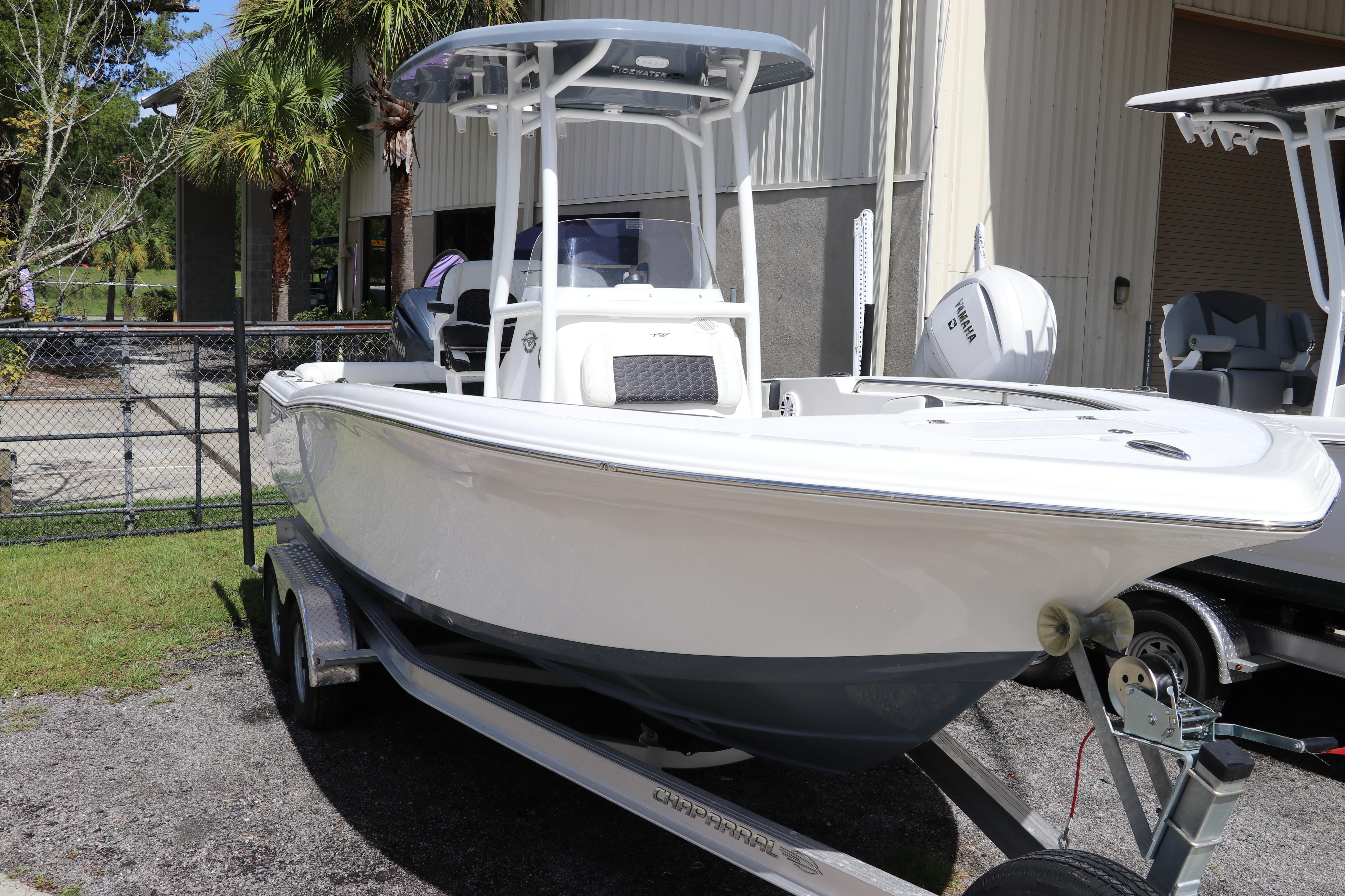 Tidewater 220 LXF 2024 Tidewater 220 LXF boat on trailer, parked outdoors near a building.