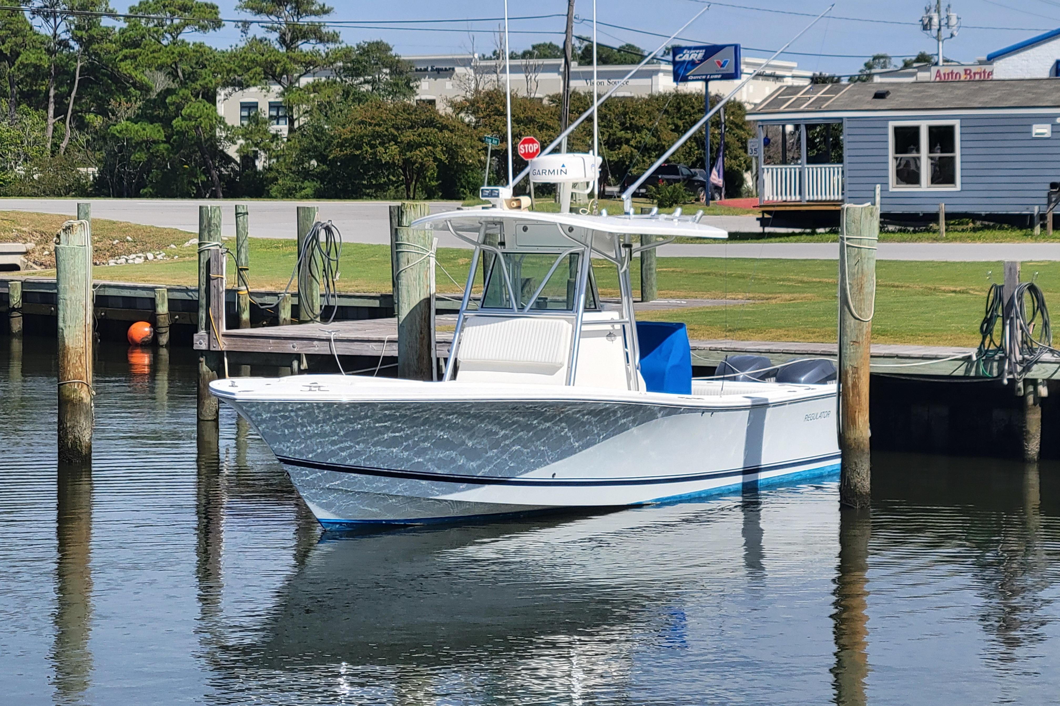Regulator 29 Forward Seating 2006 Regulator 29 Forward Seating boat docked in a marina, reflecting on calm water.