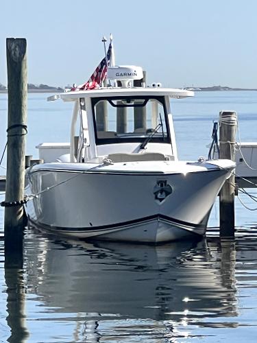 Pursuit S 328 Sport 2018 Pursuit S 328 Sport boat docked on calm water.