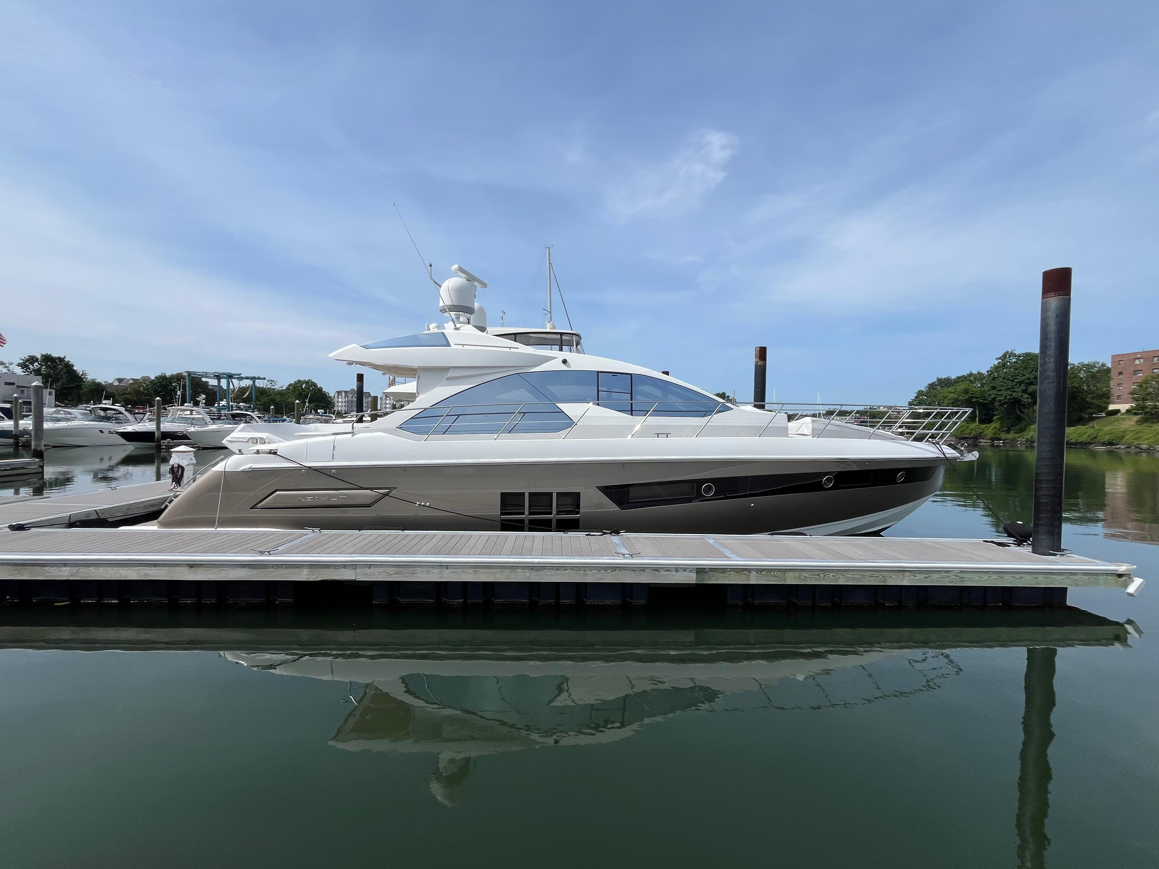 Azimut 55S 2014 Azimut 55S yacht docked at marina under clear blue sky.