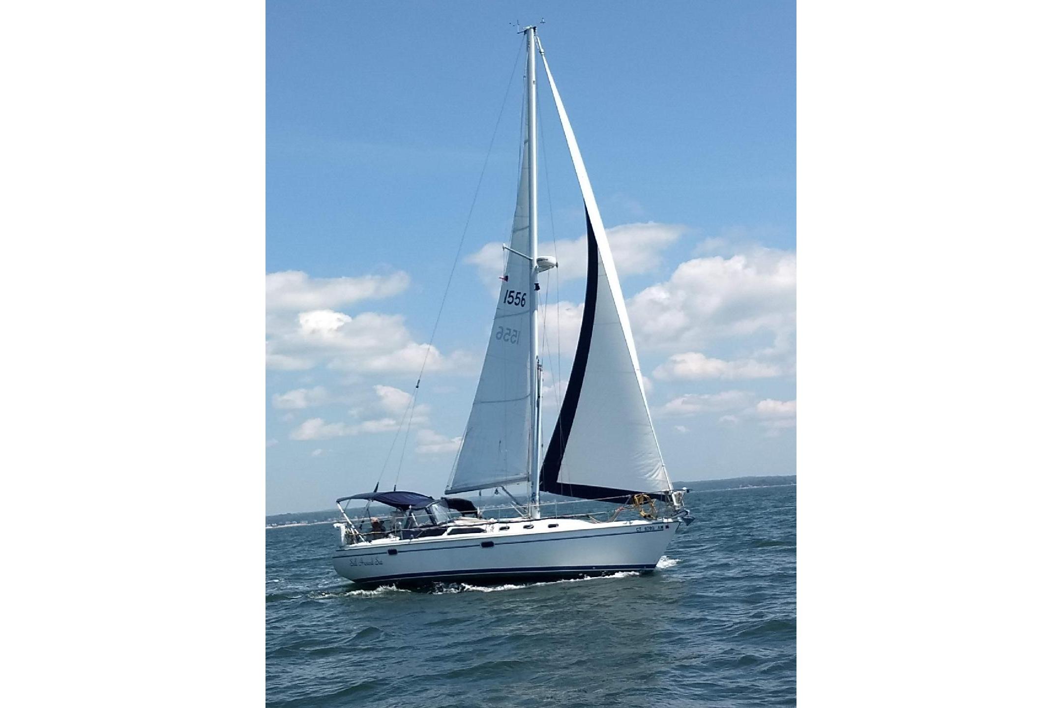 Catalina 34 MkII 2001 Catalina 34 MkII sailboat cruising on open water under a clear blue sky.
