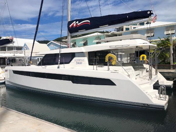 Leopard 50 2020 Leopard 50 catamaran docked at marina, featuring sleek design and modern amenities.