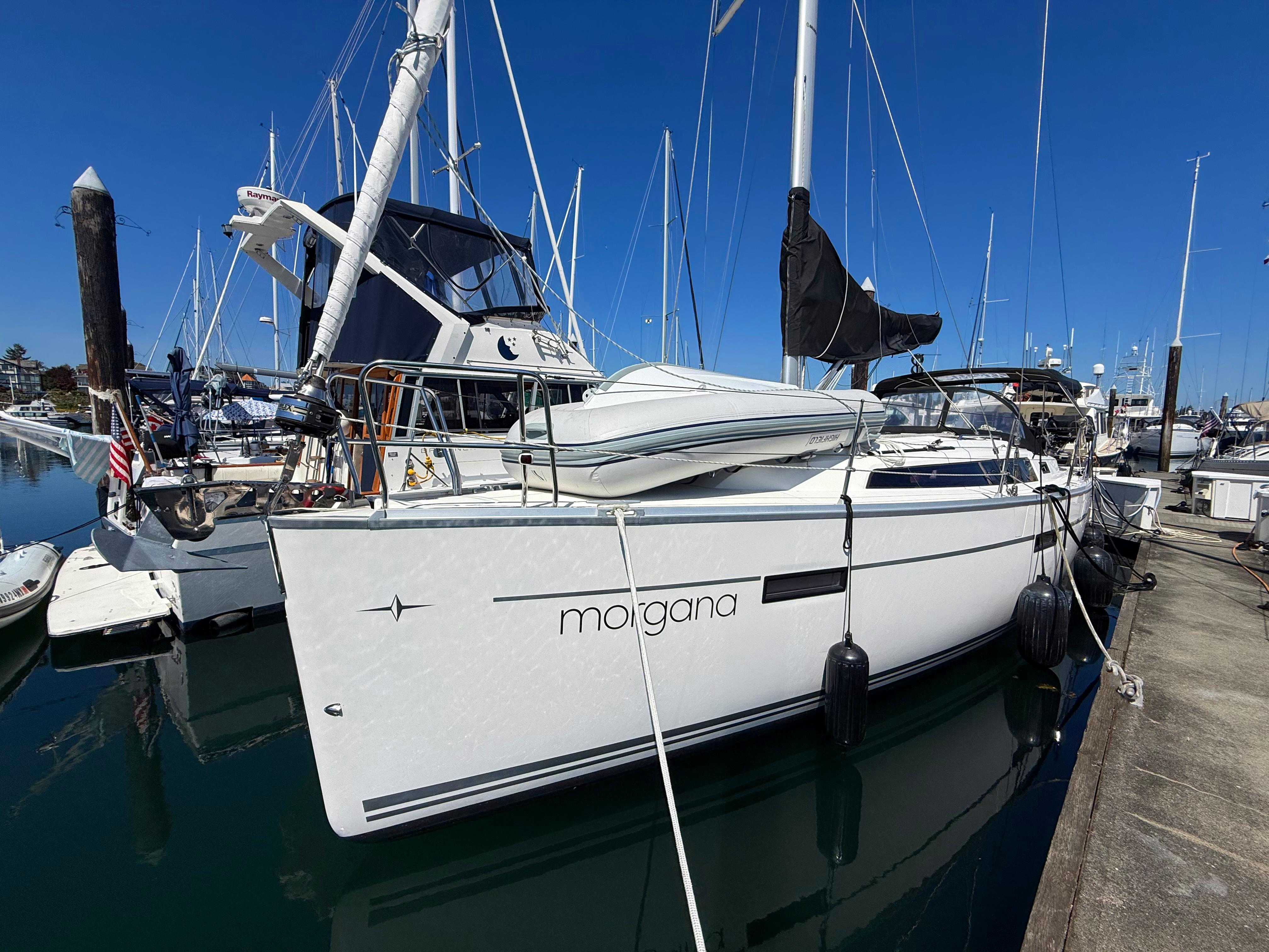 Bavaria Cruiser 37 2015 Bavaria Cruiser 37 sailboat docked at marina under clear blue sky.