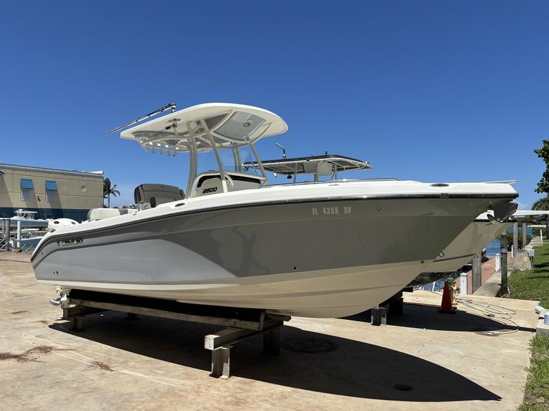 Century 2600 2019 Century 2600 boat on a dock under clear blue sky.