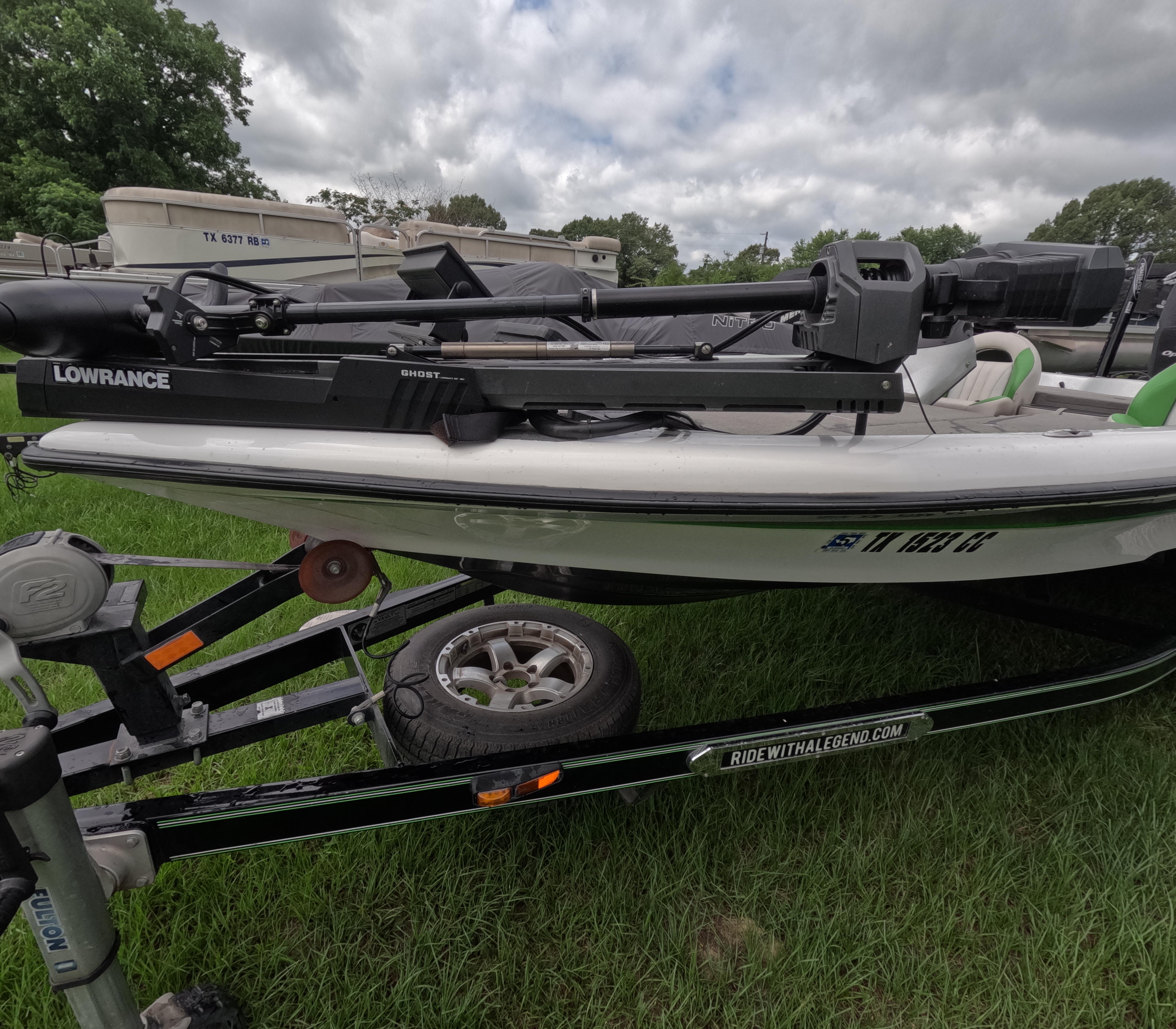Legend Boats Alpha 199 SC 2014 Legend Boats Alpha 199 SC on trailer with Lowrance equipment, parked on grass.