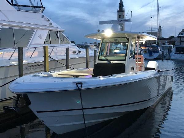 Boston Whaler 330 Outrage 2019 Boston Whaler 330 Outrage boat docked at marina during evening.